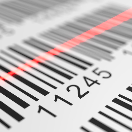 A close-up of barcode labels with a red laser scanner line moving across them.